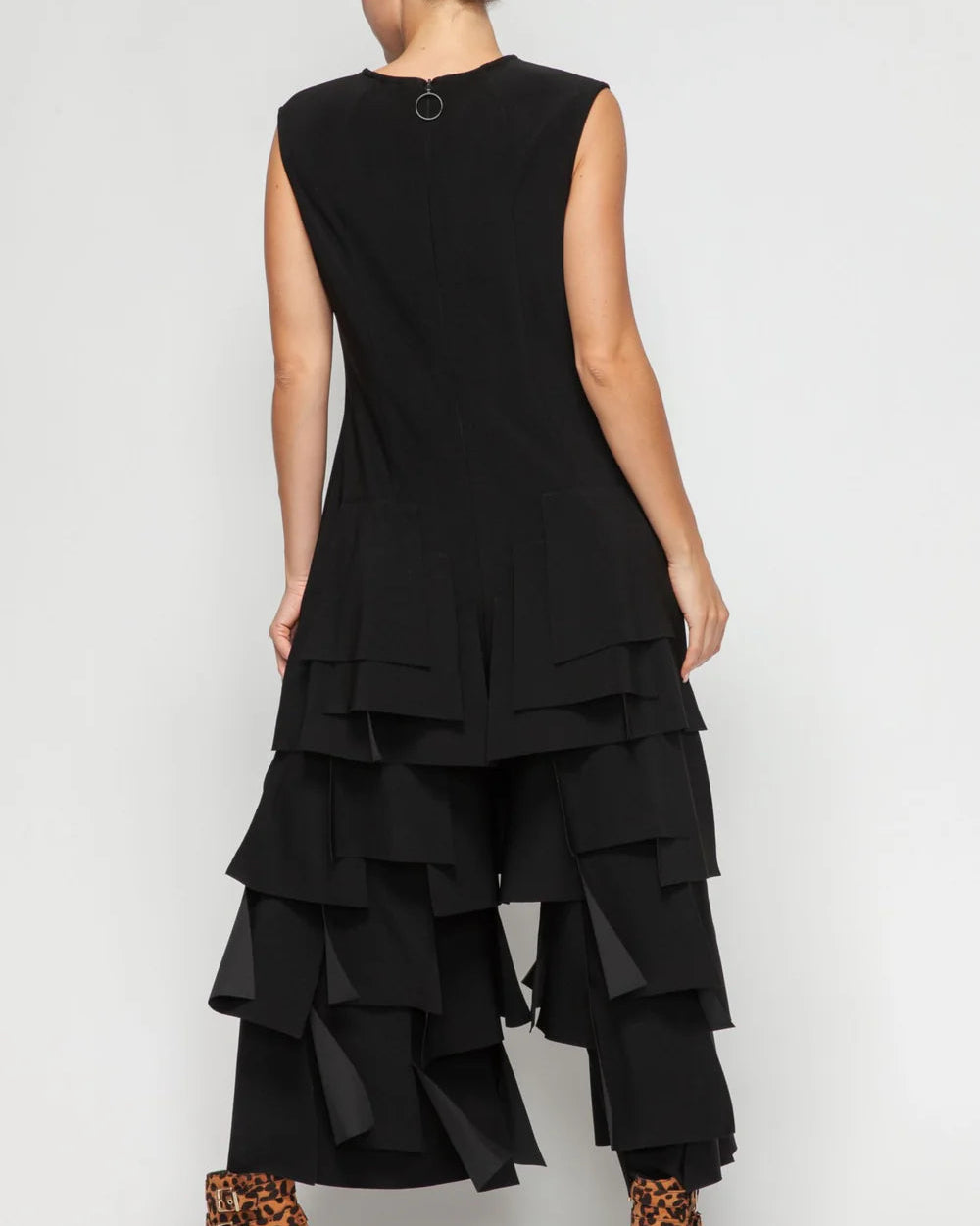 Black layered jumpsuit worn by a person on a white background
