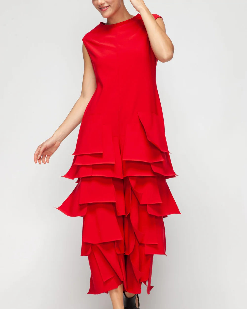 Red tiered jumpsuit worn by a person on a white background
