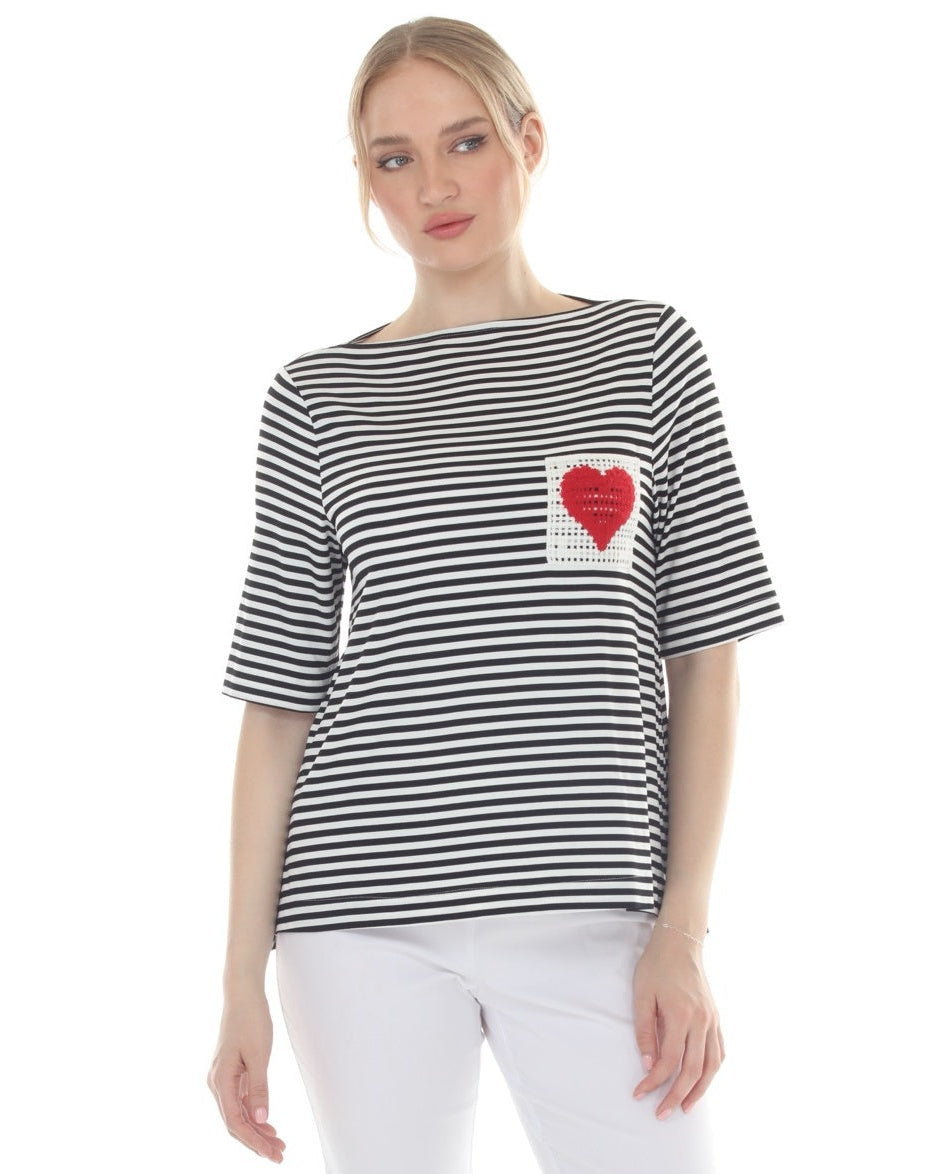 Woman wearing a black and white striped shirt with a red heart design on a white background