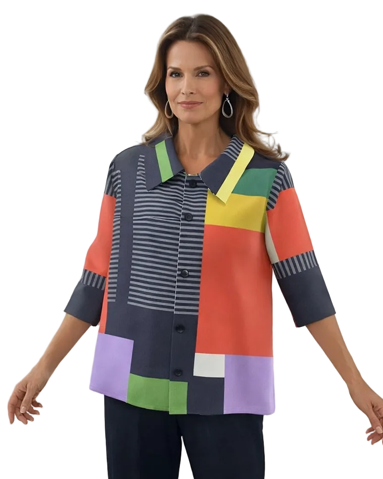 Woman wearing a colorful geometric-patterned shirt in a bright room.