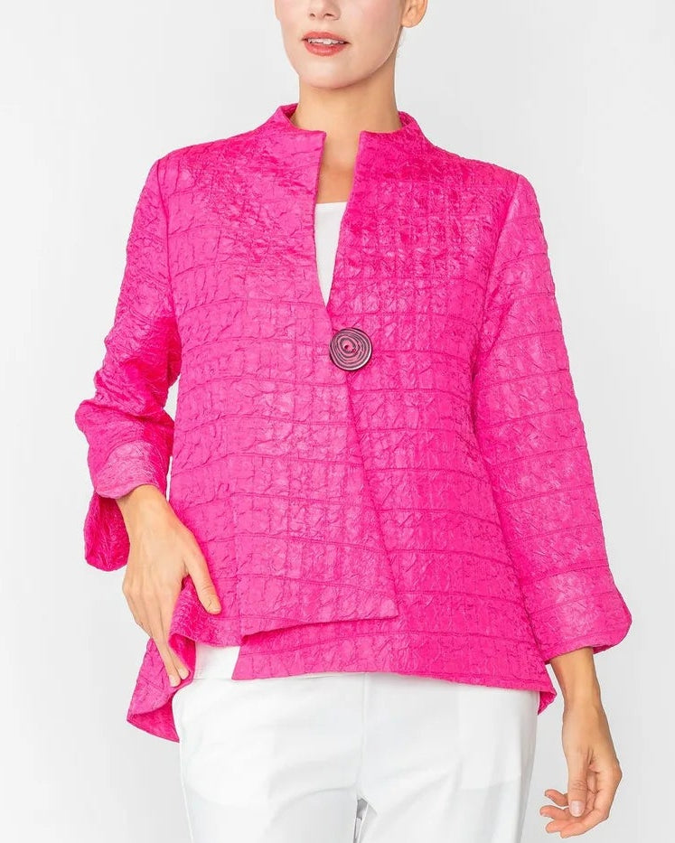 Person wearing a bright pink jacket and white pants on a white background