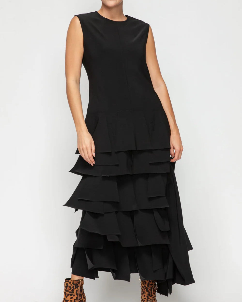 Black tiered jumpsuit worn by a person on a white background