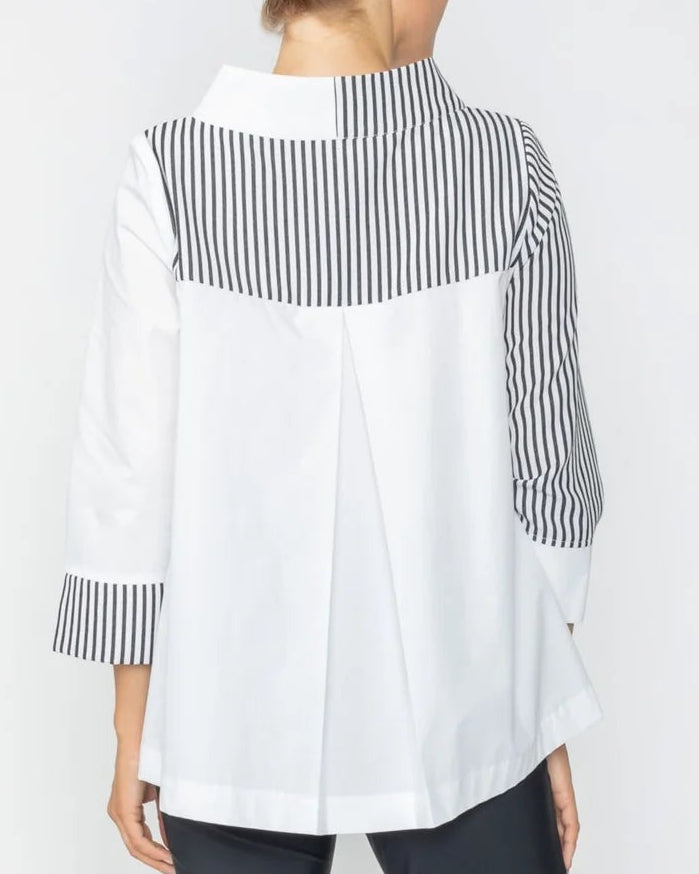 Person wearing a white shirt with black and white striped sleeves and black pants on a white background