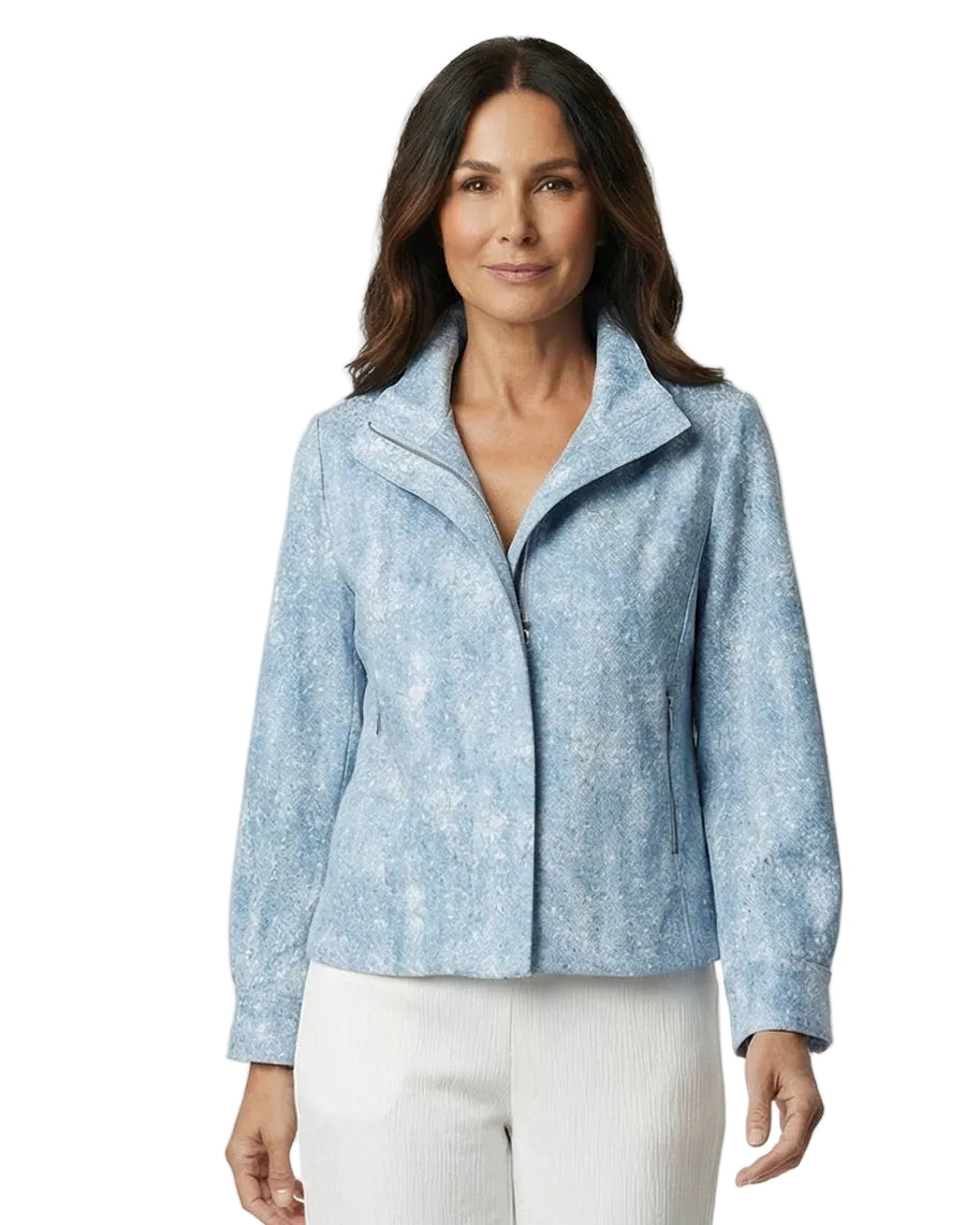 Woman wearing a light blue jacket and white pants on a white background