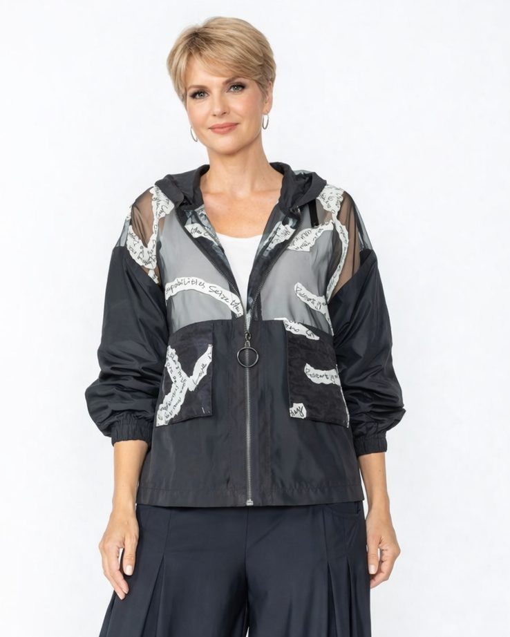 Woman wearing a black and gray jacket with white patterns and matching pants on a white background