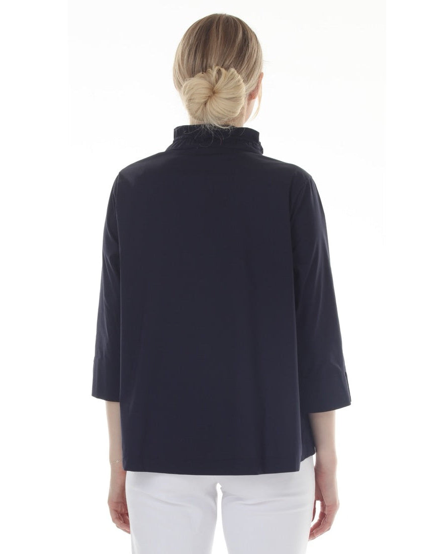 Woman wearing a Black top and white pants on a white background