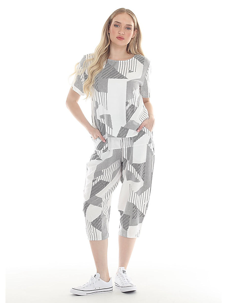 Woman wearing a patterned outfit on a white background